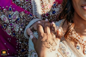   At Villa Celincordia in Cesena, Italy, the bride holds her mother’s hand, featuring intricate wedding henna designs, creating a meaningful and emotional connection between generations.